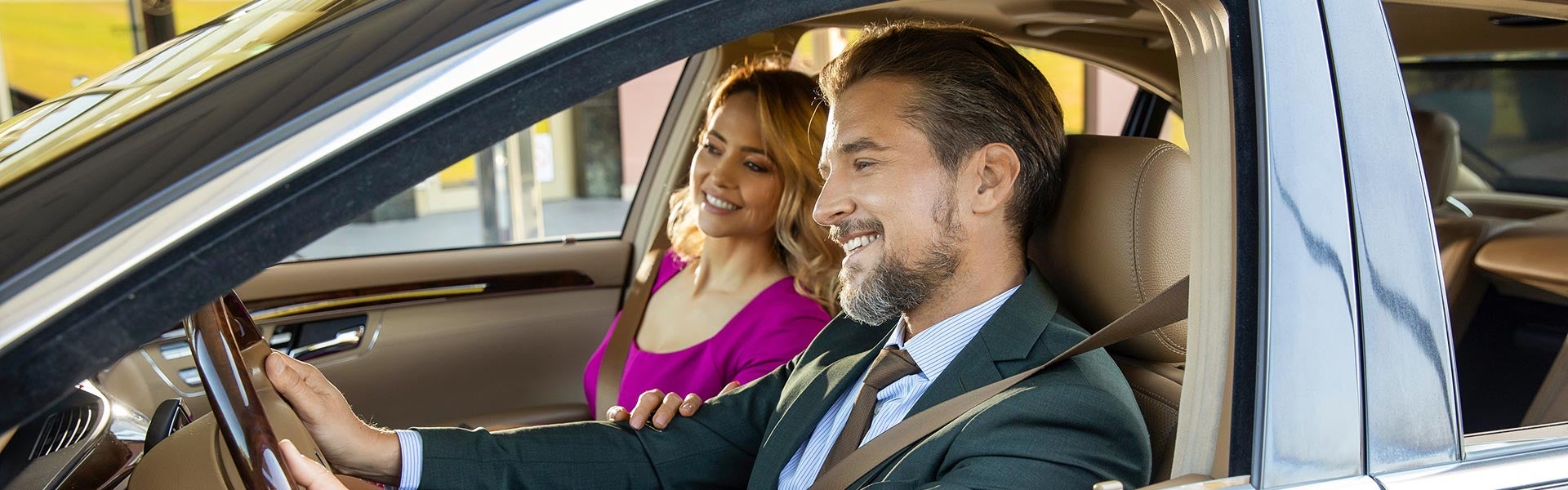 Customers sitting inside a vehicle during a car purchase experience.